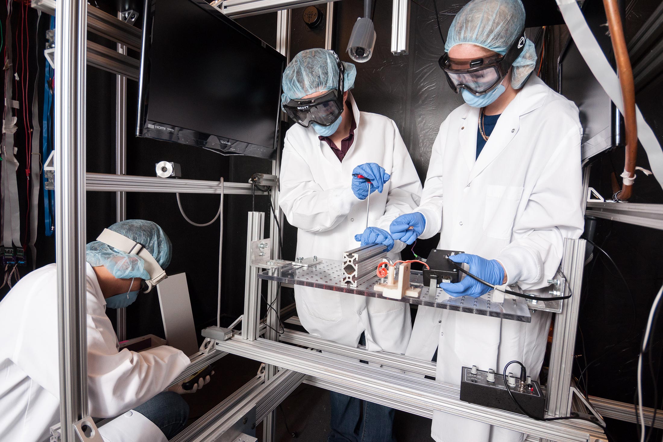 Three people working in a lab.